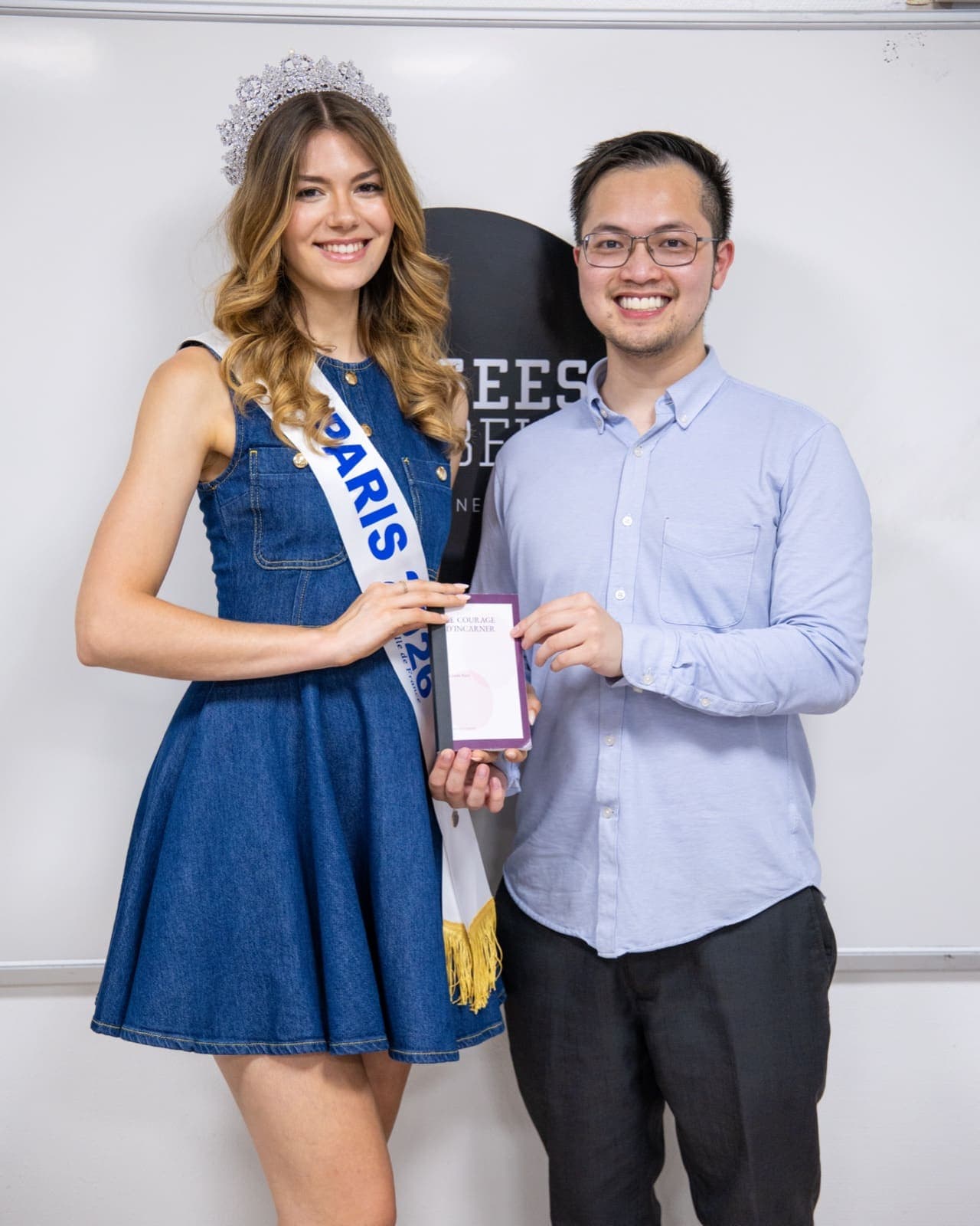 Infinite Library founder Thomas Truong with a Miss Paris titleholder, holding a book created on Infinite Library