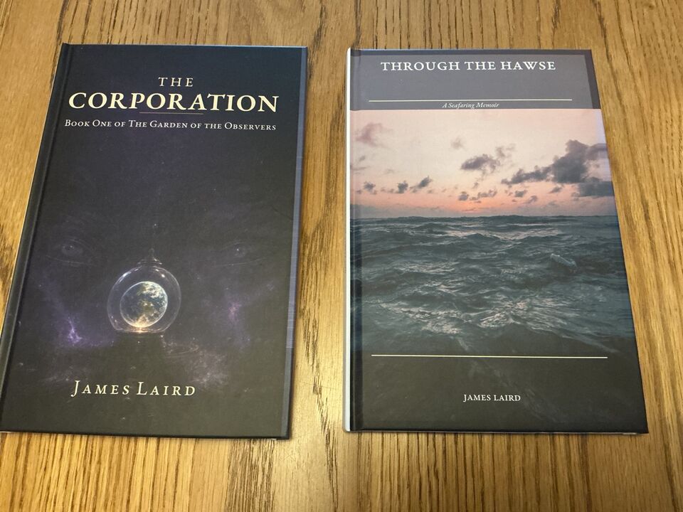 Two hardcover books on a wooden table: The Corporation and Through the Hawse, both by James Laird